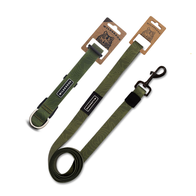 The Olive Waterproof Leash + Collar Bundle includes two durable, olive green dog accessories with topo map patterns, black brand labels, metal hardware, stink-proof and waterproof features—all in "WILDWOOD" cardboard packaging.