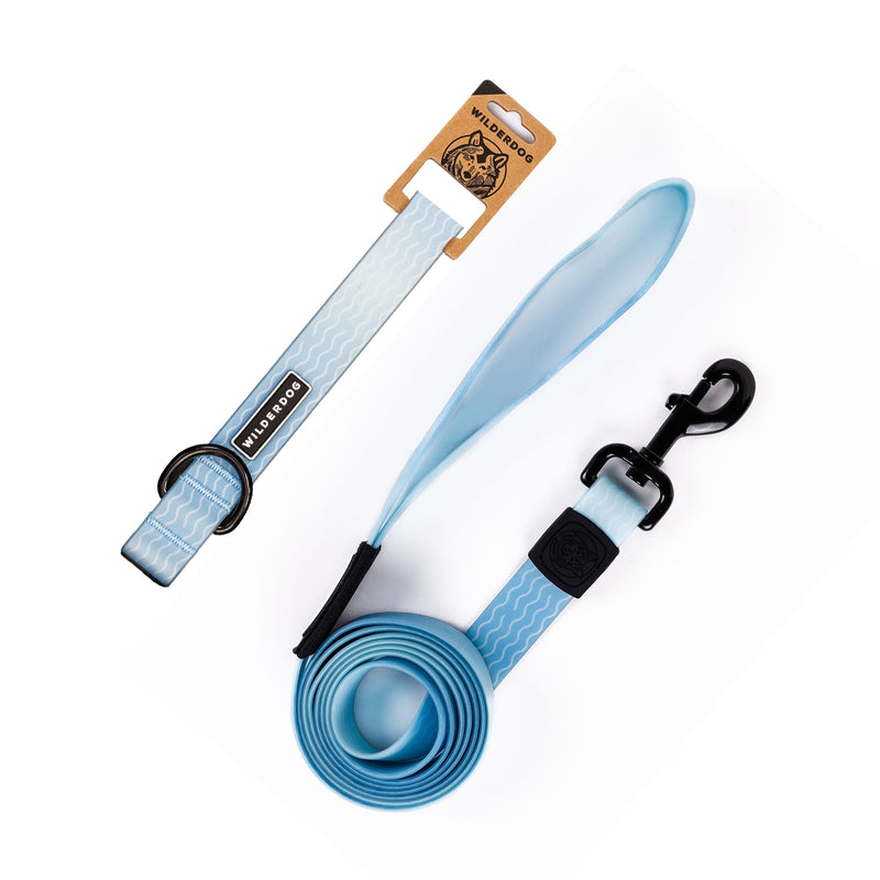 The Saltwater Waterproof Leash + Collar Bundle, shown in light blue with a wavy white pattern, black clip, and padded handle, displays the “Wild One” brand and exemplifies durable, stink-proof dog gear.