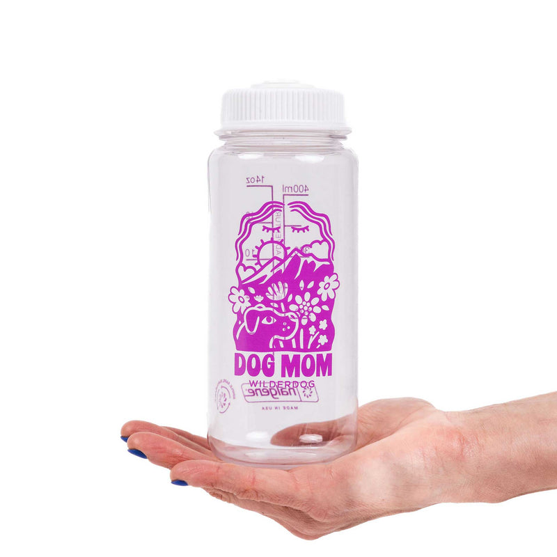 The Dog Mom Nalgene is a clear, leak-proof mini water bottle with a white lid, featuring a purple dog and floral design plus “DOG MOM” and “WILDERDOG x SIS BRIT”—perfect for proud dog moms.