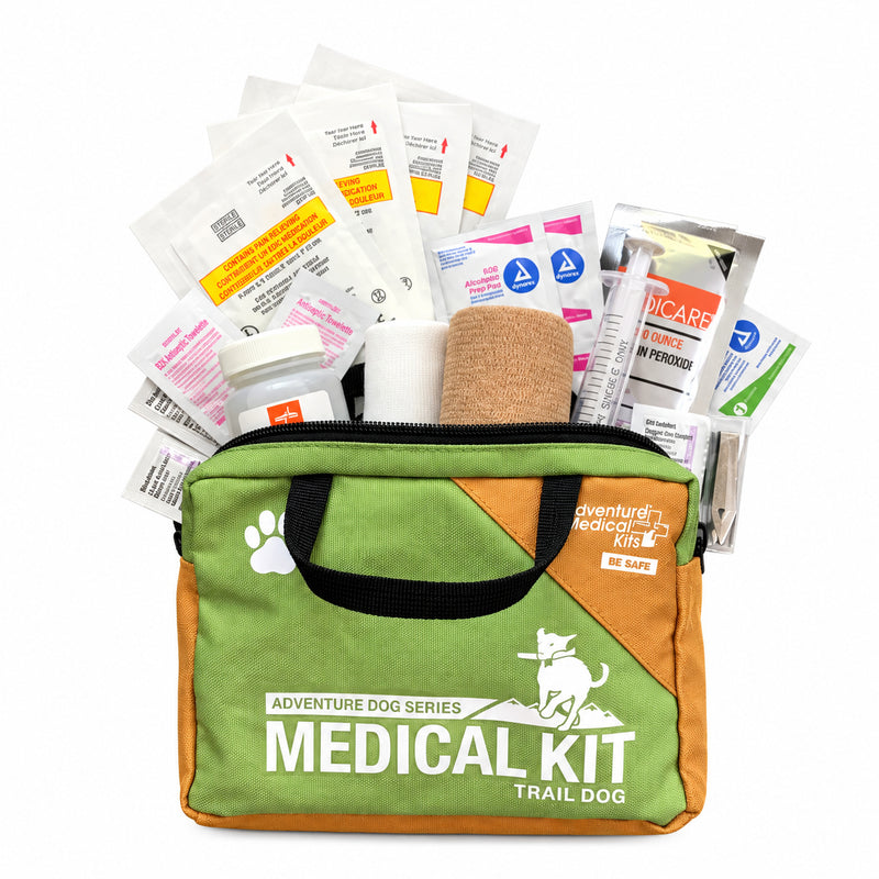 Trail Dog Medical Kit: a green and orange bag with bandages and supplies for canine first aid on the trail.