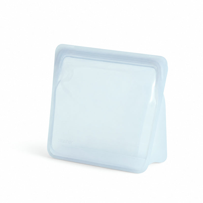 A translucent light blue Stasher™ Stand-Up Mega Bag is upright on a white background.
