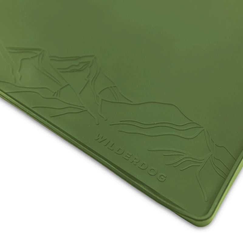 Silicone Placemat: Green non-slip pet mat with mountain design and “WILDERDOG”; dishwasher safe for easy cleaning.