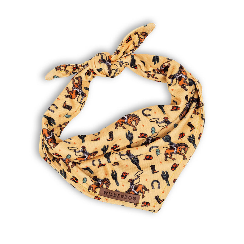 Yeehaw Bandana: yellow, cowboy & cactus print, quick-dry, tie knot, “Wilderdog” label on front.