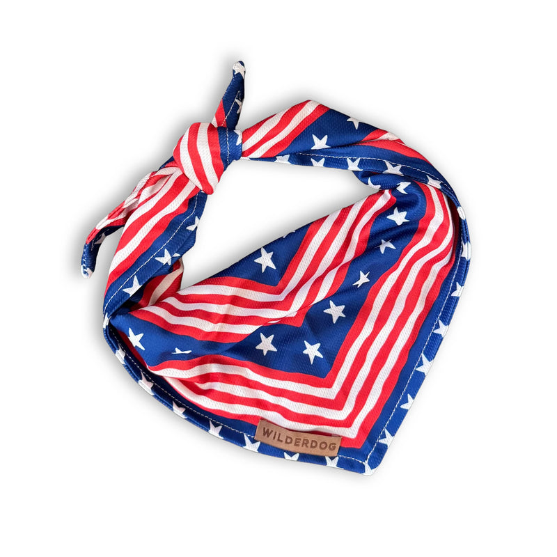 Americana Bandana: Red, white & blue dog bandana with stars, stripes, knot closure & “Wilderdog” label.