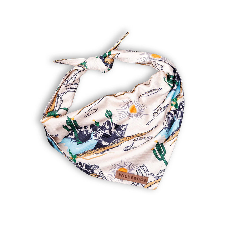 Laredo Bandana: lightweight, soft white fabric, desert landscape with cacti, mountains, sun, and “Wilderdog” label.