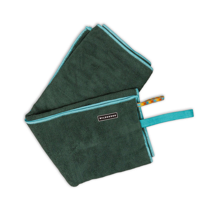 Dark green Quick Dry Towel with turquoise edges, “WILDSOOS” label, and a turquoise hanging loop.