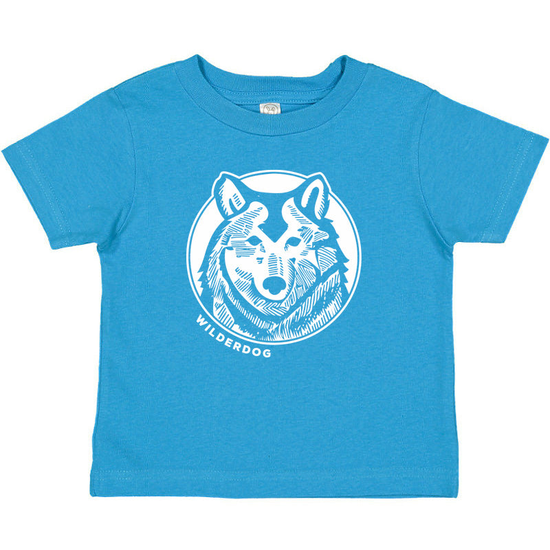 A blue toddler tee shirt featuring a white graphic design of a wolf's face encircled by a line, with the text "WILDERDOG" below the image. The t-shirt has short sleeves and a round neckline.