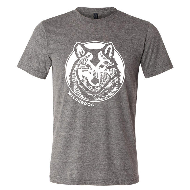 The Wilderdog Wolf Tee is a gray, sustainably produced T-shirt showcasing a graphic of a wolf's head inside a circle on the front. Below the wolf logo, the word "WILDERDOG" is printed in white uppercase letters, making it an ideal unisex addition to any wardrobe.